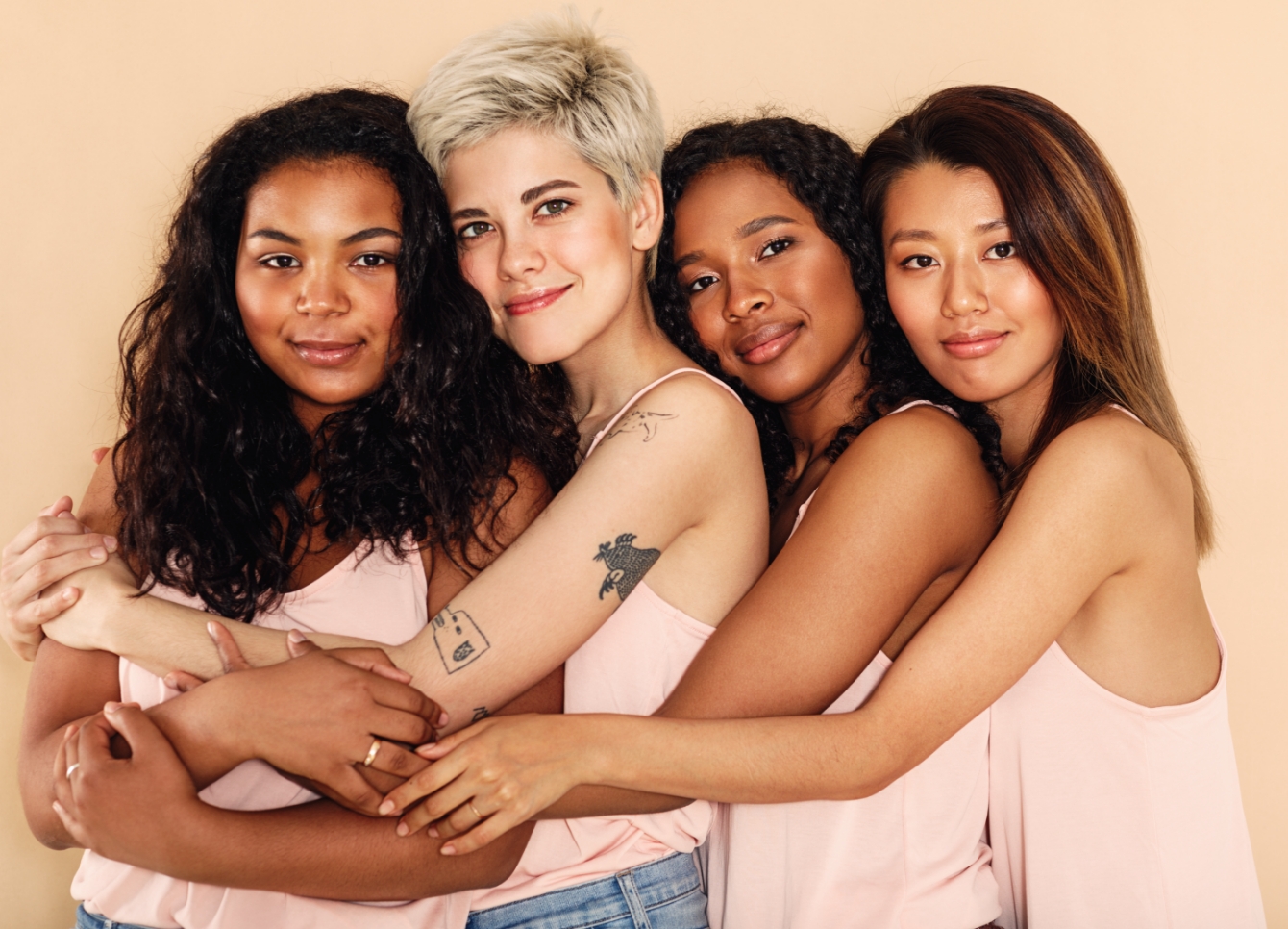 Vier junge Frauen umarmen sich
